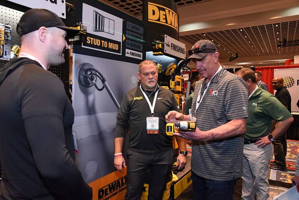 Attendees of the convention looking at tools at the Dewalt booth