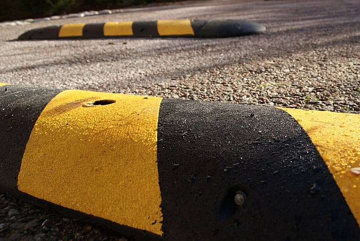 Speedbumps on a sunny morning. Placed on pavement to slow down speed of motorbikes, mopeds, cars and bicycles. Photo: JariJ Stock photo ID:682658696