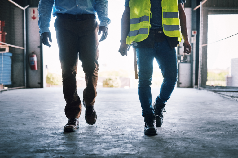 A contractor and a foreman walking on a jobsite.